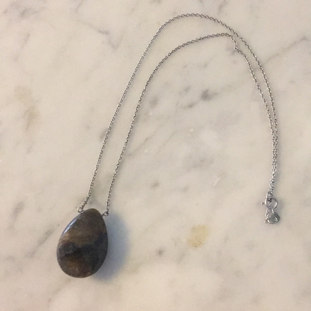 Green stone pendant on silver chain